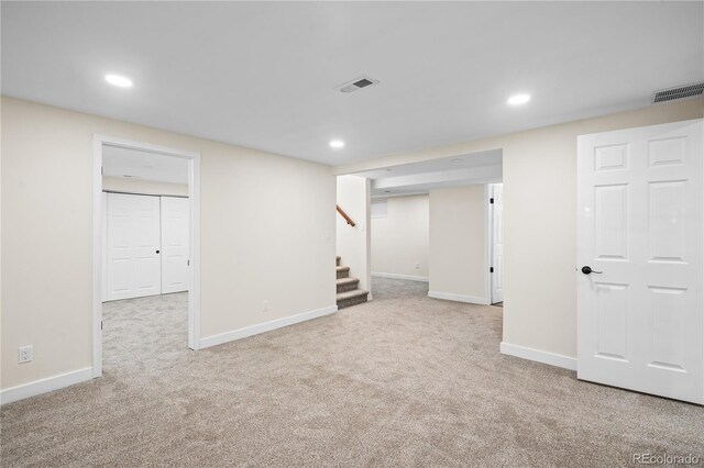 basement featuring light colored carpet