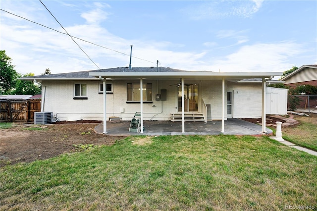 rear view of house featuring a patio area, a yard, and central AC unit