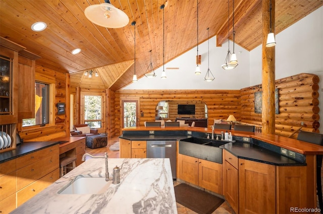 kitchen featuring dishwasher, high vaulted ceiling, open floor plan, and a sink