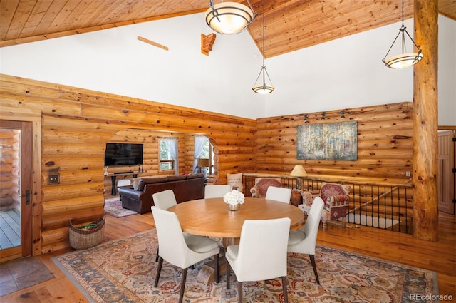 dining space with wood ceiling, wood-type flooring, and high vaulted ceiling