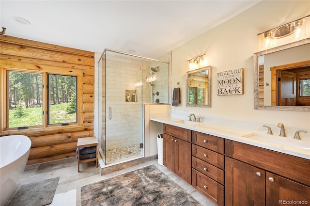 bathroom featuring a shower stall, a freestanding tub, double vanity, and a sink