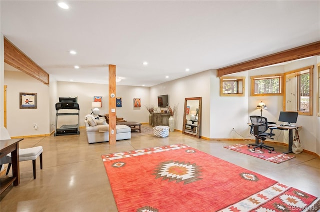 living room with recessed lighting, baseboards, and concrete floors