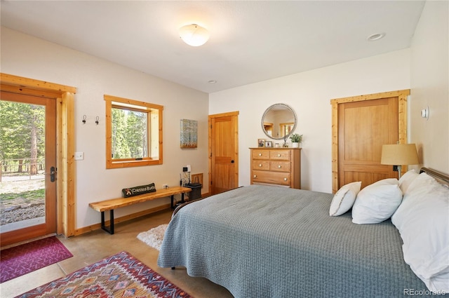 bedroom with baseboards and access to outside