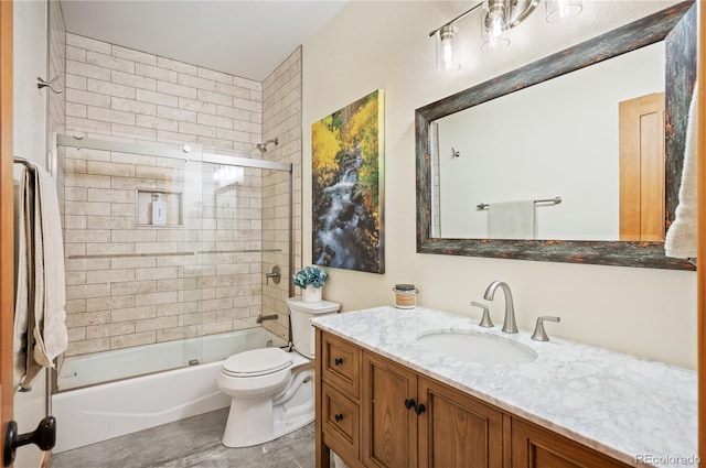 bathroom featuring enclosed tub / shower combo, toilet, and vanity