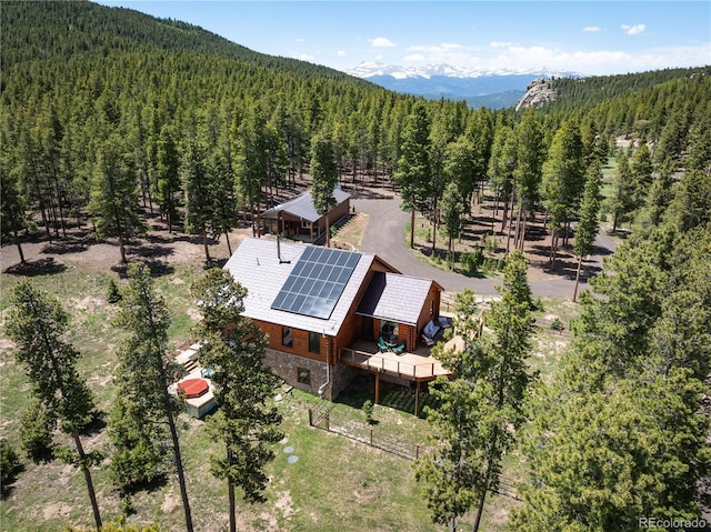 drone / aerial view with a mountain view and a forest view