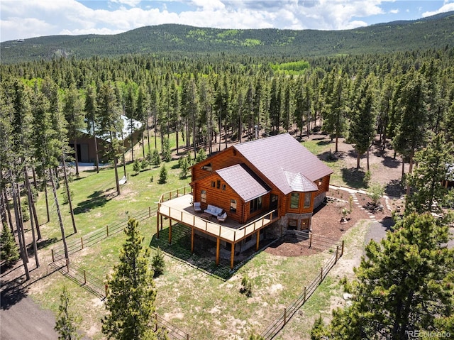 birds eye view of property featuring a mountain view and a view of trees