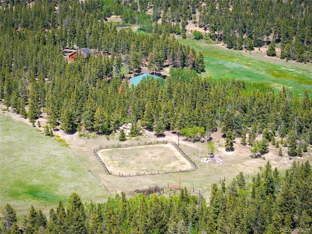 drone / aerial view featuring a rural view and a wooded view