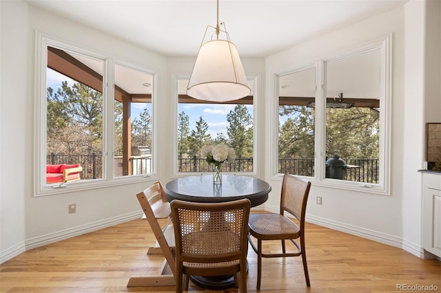 dining room featuring light wood-style floors and baseboards