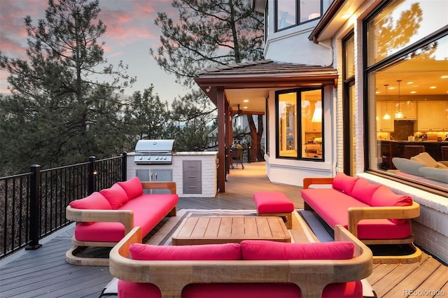 wooden terrace featuring an outdoor living space and area for grilling