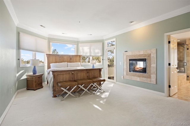 bedroom with crown molding, visible vents, a glass covered fireplace, carpet flooring, and baseboards