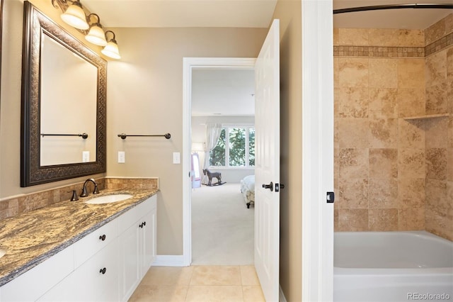 full bathroom with ensuite bath, vanity, baseboards, and tile patterned floors