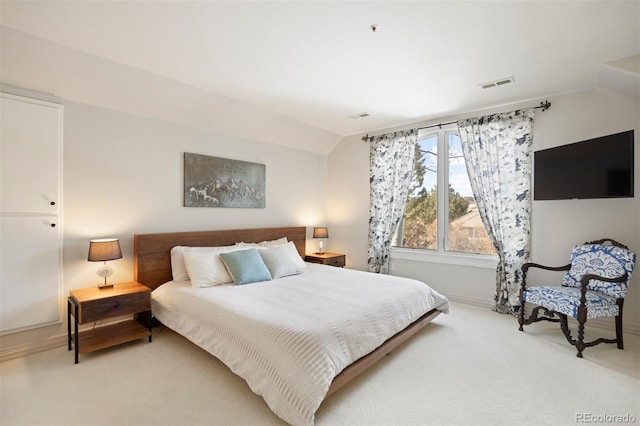 bedroom featuring visible vents, vaulted ceiling, light carpet, and baseboards