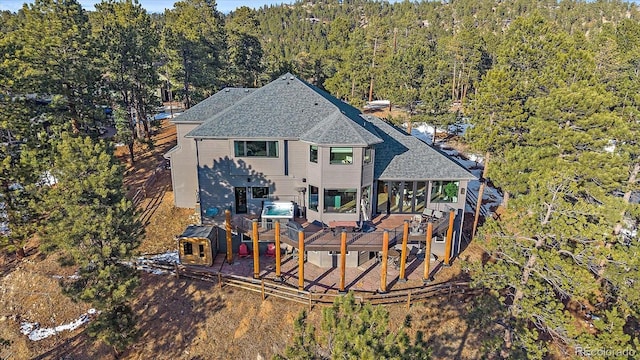 birds eye view of property with a wooded view