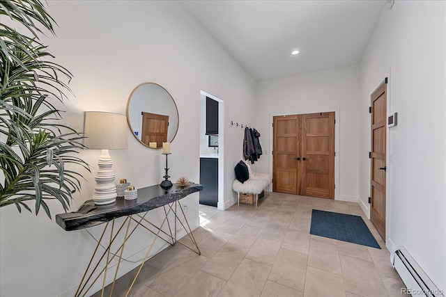 entrance foyer with light tile patterned floors, a baseboard radiator, baseboards, and recessed lighting