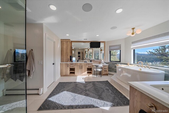 full bath featuring tile patterned flooring, an enclosed shower, baseboard heating, vanity, and a freestanding tub