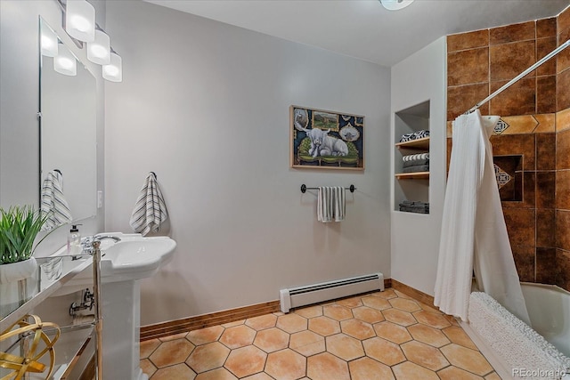 full bath with a sink, baseboards, a baseboard heating unit, and shower / bath combination with curtain