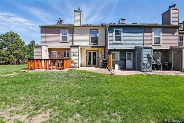 3525 Queen Anne Way, Colorado Springs, CO 80917 - back of house featuring a chimney, a lawn, a wooden deck, and a patio