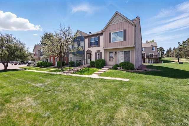 3525 Queen Anne Way, Colorado Springs, CO 80917 - multi unit property with board and batten siding, a front lawn, a chimney, and a residential view