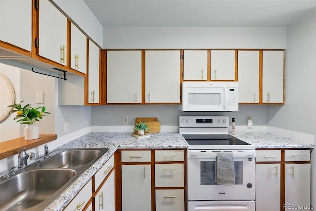3525 Queen Anne Way, Colorado Springs, CO 80917 - kitchen featuring white appliances, a sink, and white cabinets