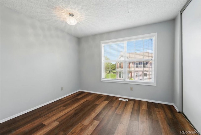 3525 Queen Anne Way, Colorado Springs, CO 80917 - unfurnished room with wood finished floors, a textured ceiling, and baseboards