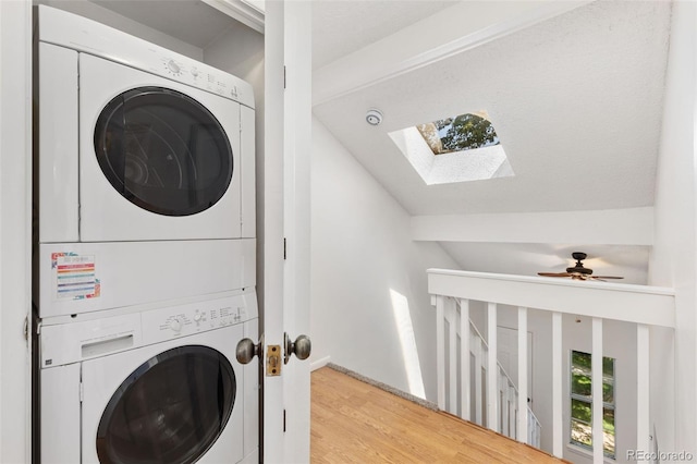 2013 S Helena St Unit B, Aurora, CO 80013 - washroom with estacked washer and dryer, a skylight, and wood finished floors