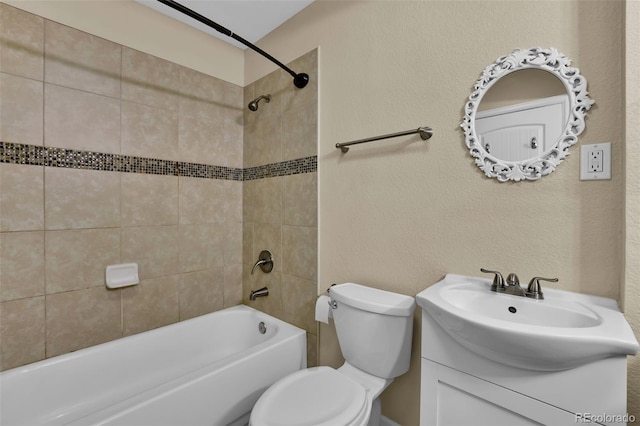 full bath with vanity, toilet, bathing tub / shower combination, and a textured wall