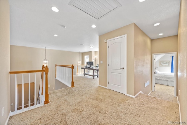 hallway with light colored carpet