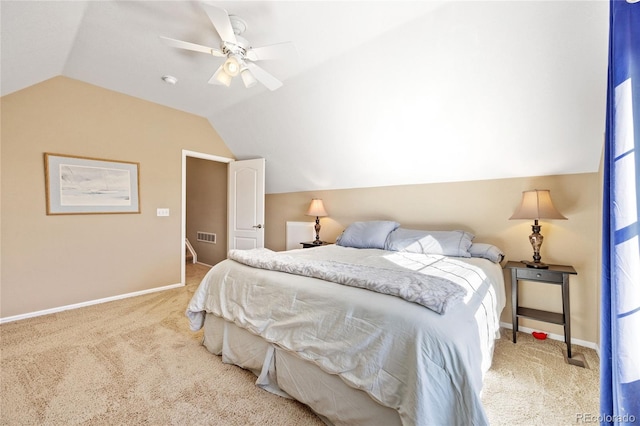 carpeted bedroom with ceiling fan and vaulted ceiling