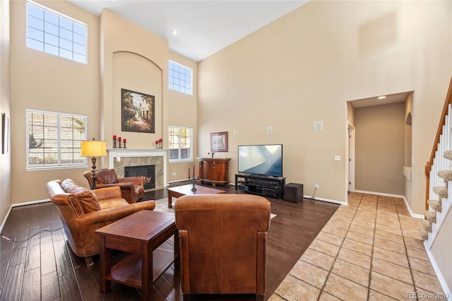 living room with hardwood / wood-style floors, a high ceiling, and a wealth of natural light