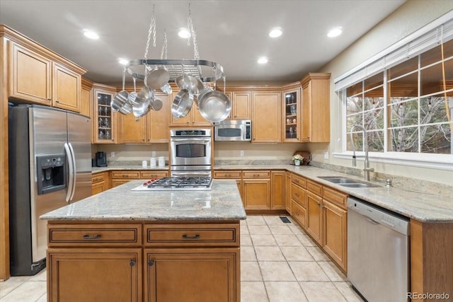 6987 Esperanza Dr, Castle Pines, CO 80108 - kitchen with appliances with stainless steel finishes, a sink, a kitchen island, light tile patterned floors, and recessed lighting