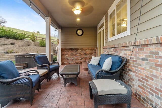 6987 Esperanza Dr, Castle Pines, CO 80108 - view of patio / terrace featuring a hot tub, an outdoor hangout area, and fence