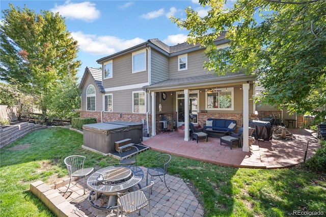 6987 Esperanza Dr, Castle Pines, CO 80108 - rear view of house with a hot tub, a patio, and an outdoor living space with a fire pit