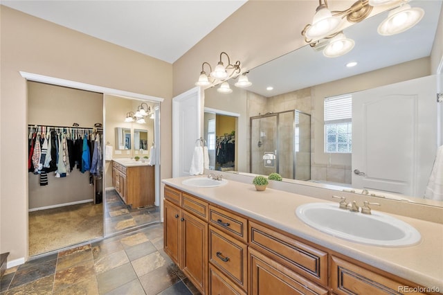 6987 Esperanza Dr, Castle Pines, CO 80108 - full bath featuring a stall shower, a walk in closet, double vanity, stone finish flooring, and baseboards