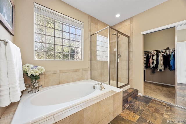 6987 Esperanza Dr, Castle Pines, CO 80108 - full bathroom with a shower stall, a garden tub, a walk in closet, baseboards, and recessed lighting