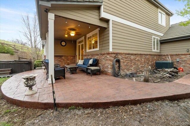 6987 Esperanza Dr, Castle Pines, CO 80108 - view of patio with a hot tub and central air condition unit