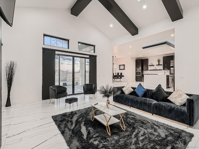 living room with beam ceiling and high vaulted ceiling