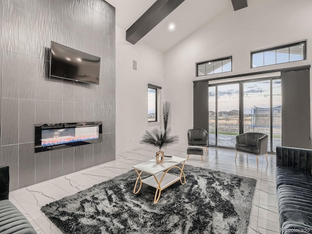 living room with high vaulted ceiling, tile walls, and a fireplace