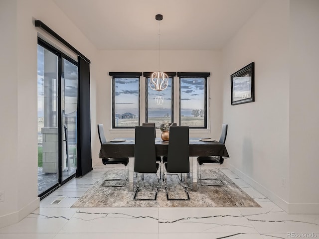 dining area featuring a notable chandelier and a wealth of natural light