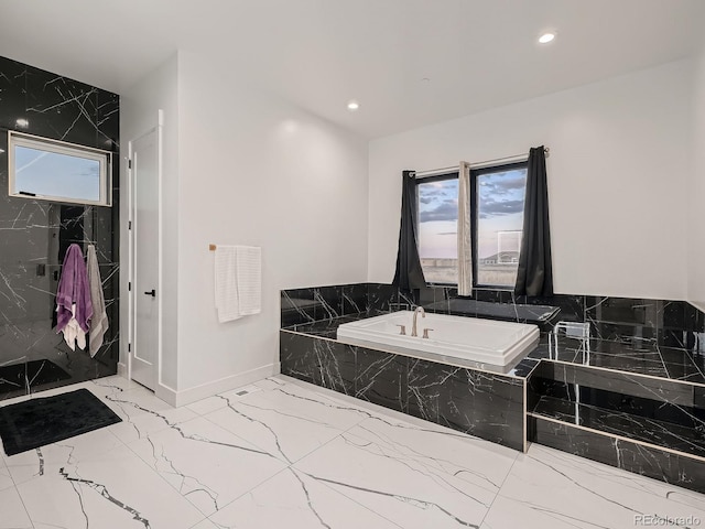 bathroom with tiled bath