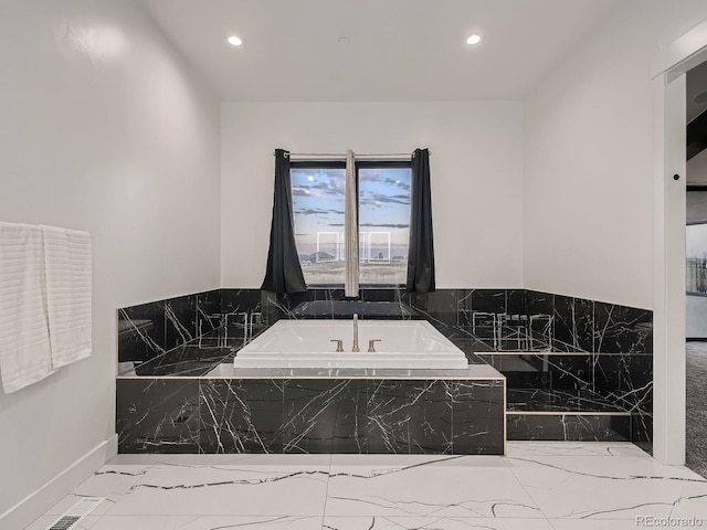 bathroom featuring tiled bath