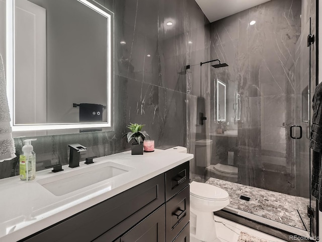 bathroom with vanity, an enclosed shower, tile walls, toilet, and decorative backsplash