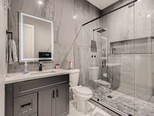 bathroom with tile walls, decorative backsplash, walk in shower, vanity, and toilet