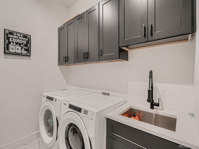 washroom featuring cabinets, washer and dryer, and sink