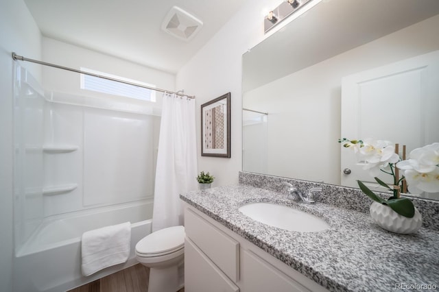 full bath featuring visible vents, toilet, shower / bath combo with shower curtain, wood finished floors, and vanity