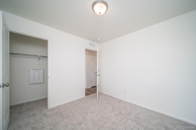 unfurnished bedroom featuring a closet, visible vents, baseboards, and carpet