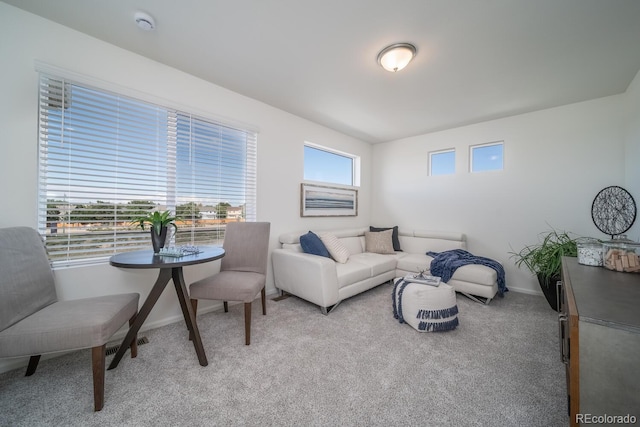 living room with light carpet and baseboards