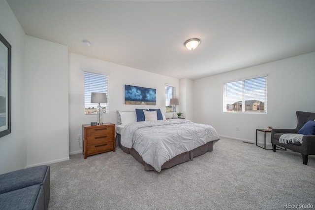 bedroom featuring baseboards and carpet