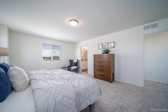 bedroom with baseboards, visible vents, carpet floors, and connected bathroom