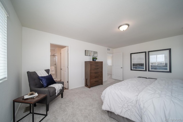 bedroom with visible vents, light carpet, and baseboards