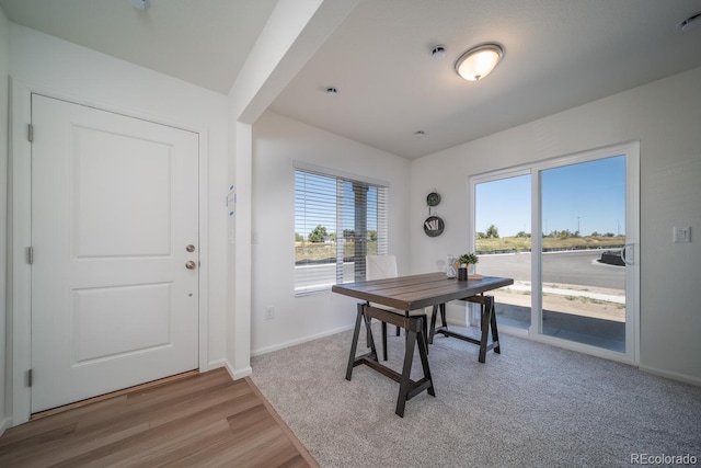 dining room with light wood finished floors and baseboards